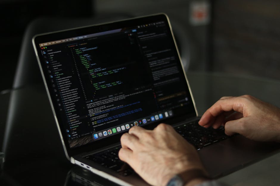 A close-up view of a computer screen displaying lines of colorful programming code, with a focus on JavaScript syntax including functions, variables, and loops. The background is slightly blurred, emp